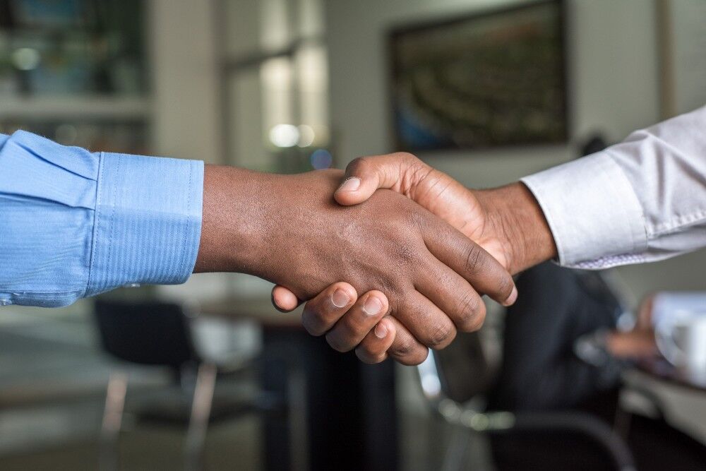 A handshake between two people in shirts